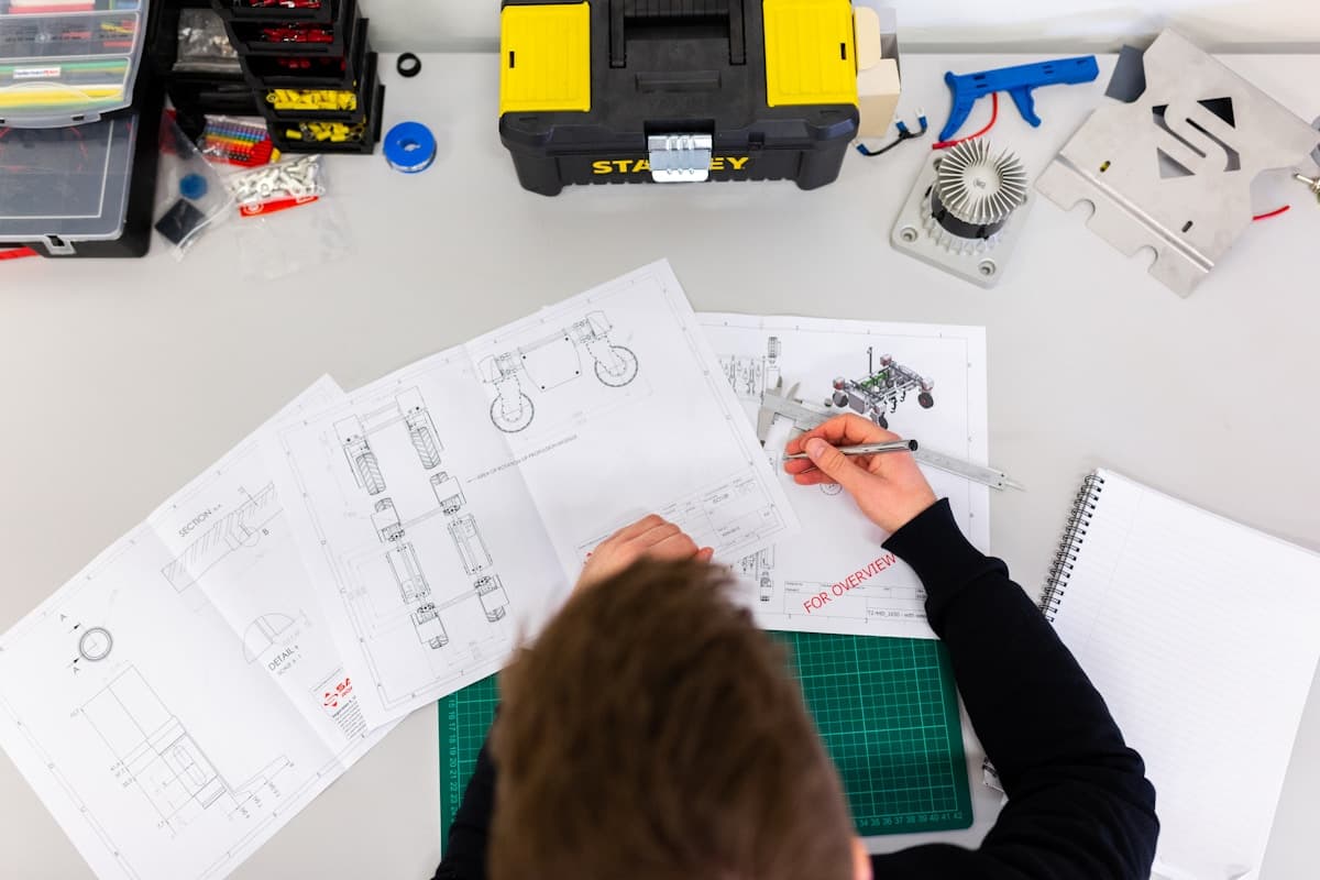 Engineer in a hard hat reviewing technical plans in an industrial facility